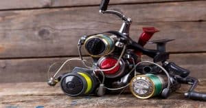 3 Nice Spinning Reels on wooden background